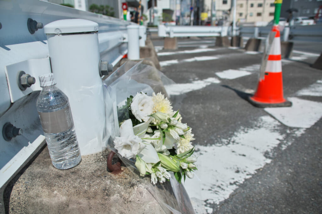 安倍晋三元首相が銃撃された事件から１カ月となり、現場付近に手向けられた花と水。夕方には市の職員によって撤去された　=８日午後、奈良市